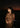 Woman in a gold saree with a cityscape at night